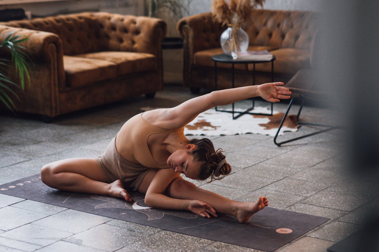 Woman practicing yoga indoors, showcasing flexibility and calmness.